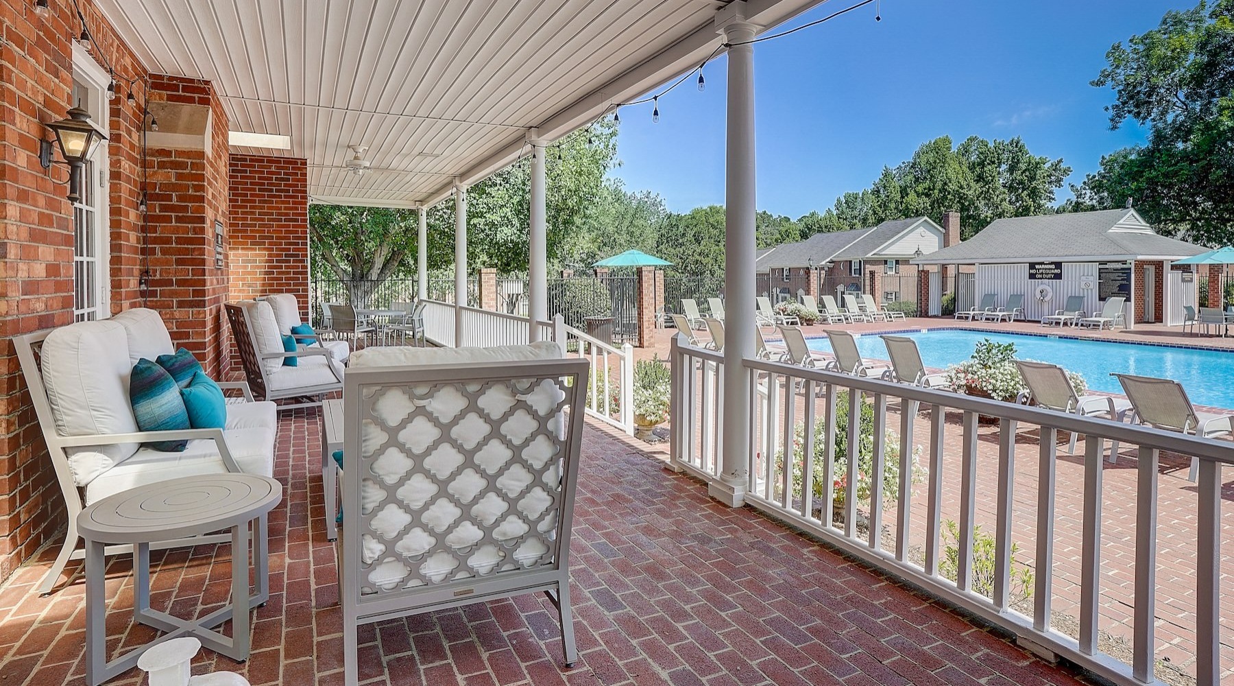 a deck with chairs and a pool