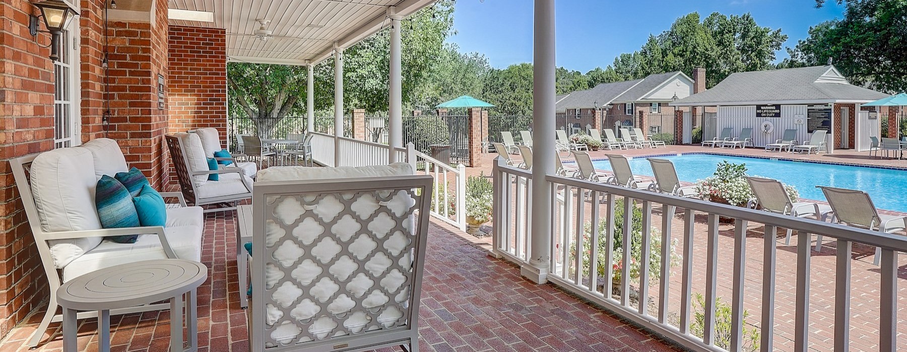 a deck with chairs and a pool