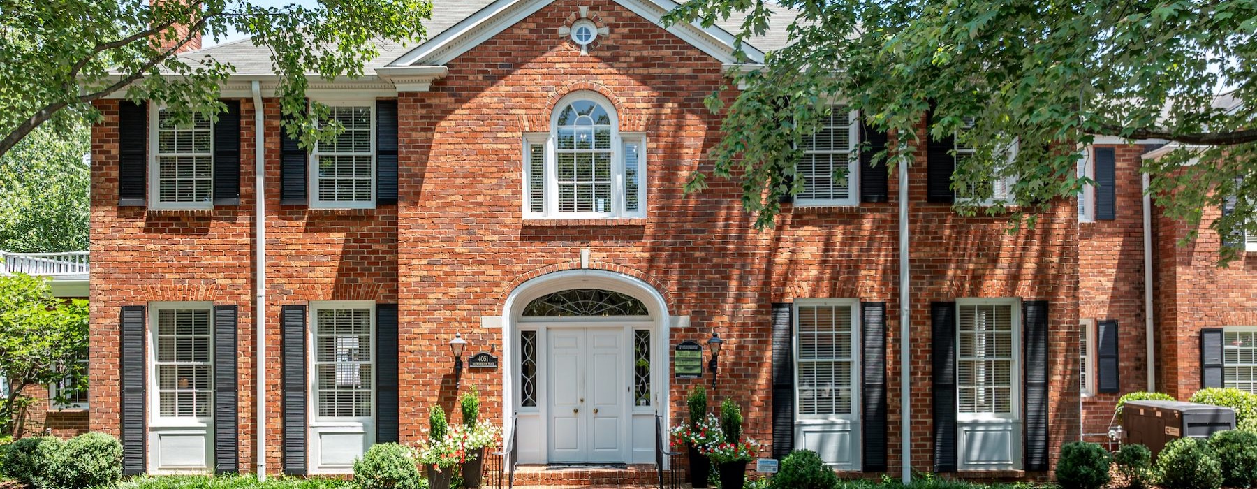 a brick building with a white door
