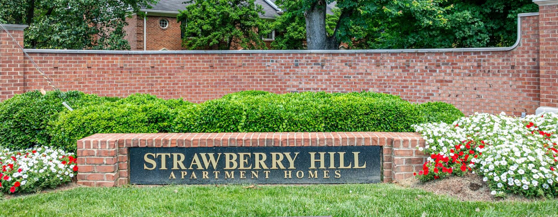 a sign in front of a brick wall